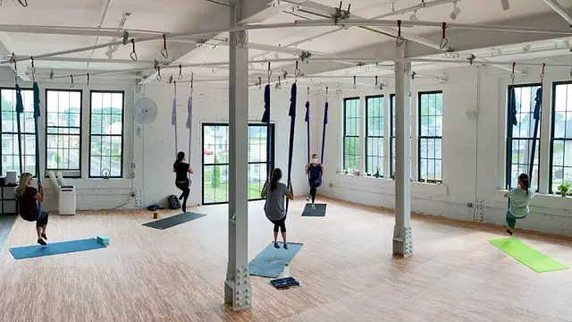 Earth & Aerial Yoga in Hudson MA reopens post pandemic showing their commitment to connection & grounding that only being near others can create.