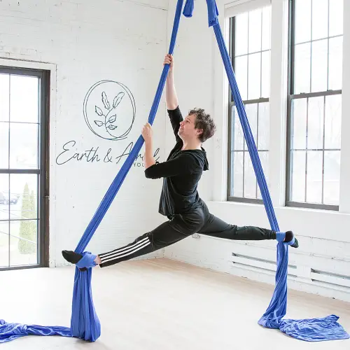 Man doing the splits in aerial split silks at Earth & Aerial Yoga