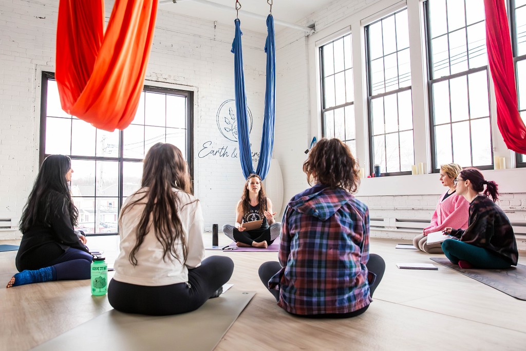 Aerial yoga teacher training students practicing