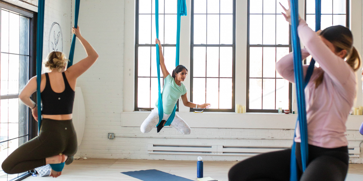 Teaching aerial yoga students