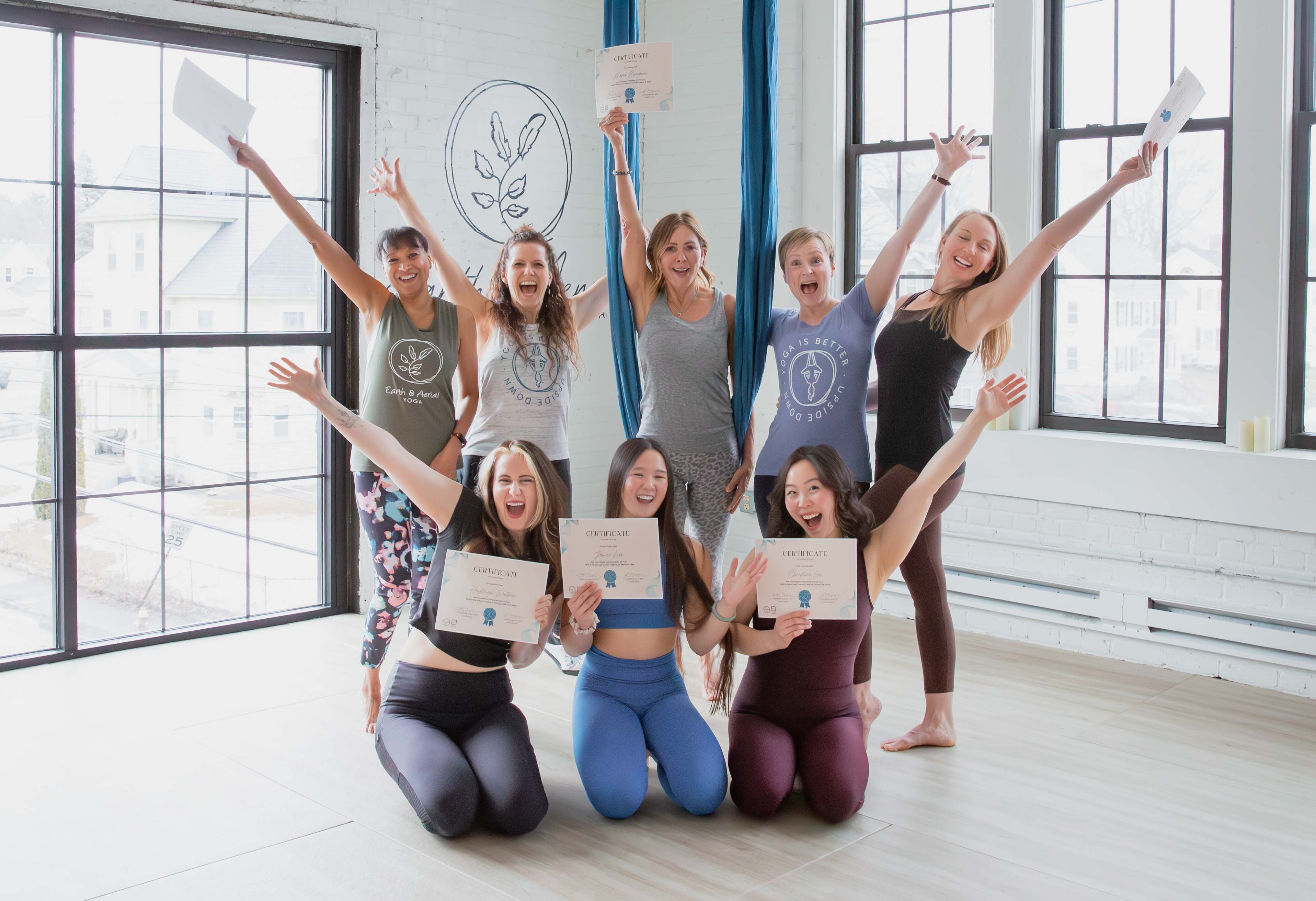 Aerial yoga teacher training students practicing in the studio